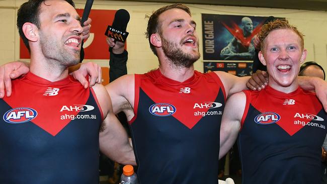 Cameron Pedersen, Jack Watts and Clayton Oliver sing the Melbourne song after Monday’s win. Picture: Getty Images