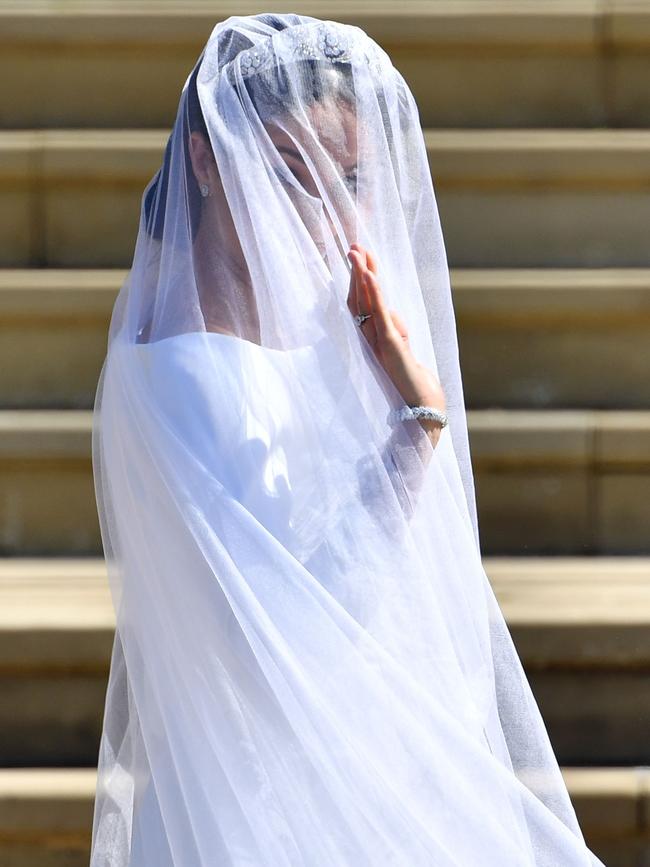 A windy moment for the bride. Picture: AFP