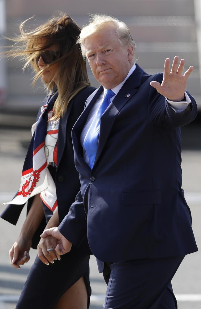 Mr Trump waves as he holds Mrs Trump’s hand ahead of a busy two days of events in London. Picture: AP Photo/Kirsty Wigglesworth