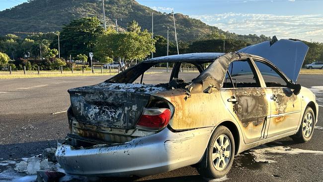 A stolen silver Toyota Camry set on fire behind the Officeworks in Hermit Park about 4am on Monday. Picture: Natasha Emeck