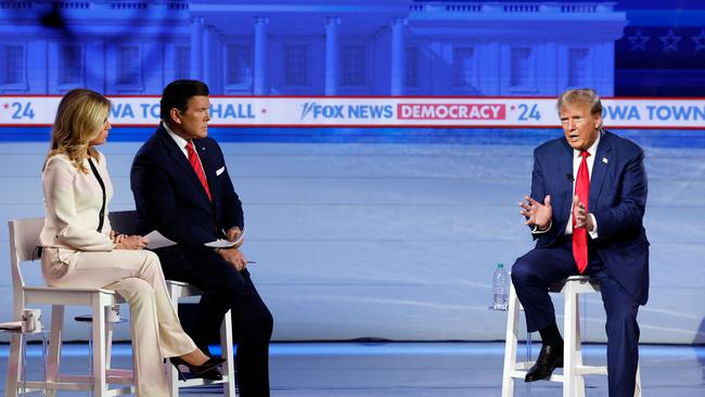 Donald Trump speaks as moderators Bret Baier and Martha MacCallum look on during a ‘town hall’ in Des Moines, Iowa, today. Mr Trump’s legal problems are mounting, with doubts over his ability to run for president becoming more legitimate. Picture: AFP