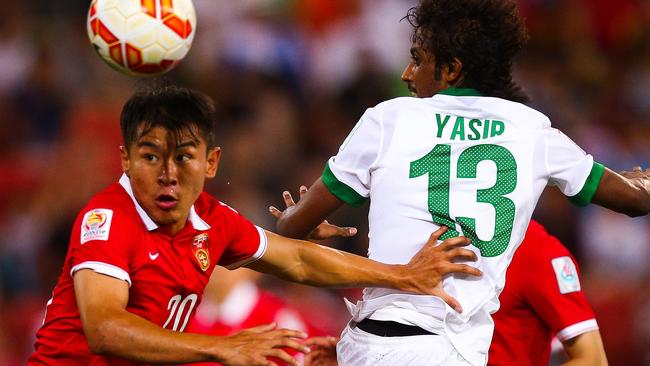 Yu Hanchao (L) of China fights for the ball with Yasir Alshahrani (R) of Saudi Arabia during the first round Asian Cup football match between China and Saudi Arabia at the Suncorp Stadium in Brisbane on January 10, 2015. AFP PHOTO / PATRICK HAMILTON ---IMAGE RESTRICTED TO EDITORIAL USE - STRICTLY NO COMMERCIAL USE---