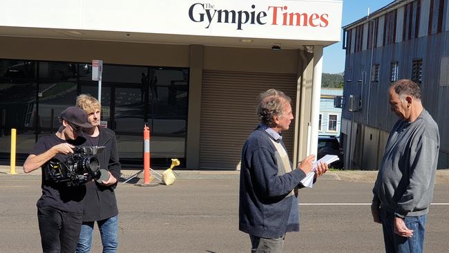 Michael Condon talks with reporter Arthur Gorrie during documentary filming outside The Gympie Times office.