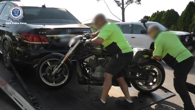 Police seized a motorbike and luxury vehicles during associated raids.