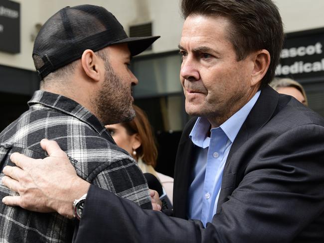 Mascot Towers apartment owner Fabiano Santos (left) gets an embrace from NSW Minister for Better Regulation and Innovation, Kevin Anderson (right) after a press conference at the Mascot Towers in Mascot, Sydney, Sunday, June 23, 2019. The NSW Government is offering an one-off temporary residential accommodation package for displaced residents of the Mascot Towers, after they were  evacuated as a precaution after cracks were discovered in the building. (AAP Image/Bianca De Marchi) NO ARCHIVING