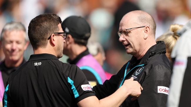 ADELAIDE, AUSTRALIA - AUGUST 27: Josh Carr, Midfield Coach of the Power talks to Ken Hinkley, Senior Coach of the Power at quarter time during the 2023 AFL Round 24 match between the Port Adelaide Power and the Richmond Tigers at Adelaide Oval on August 27, 2023 in Adelaide, Australia. (Photo by Sarah Reed/AFL Photos via Getty Images)