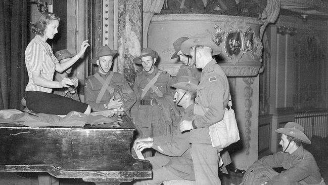 Australian Infantry Force soldiers at the piano with Miss Margaret Vyner in London, June, 1940. Picture: State Library of Victoria