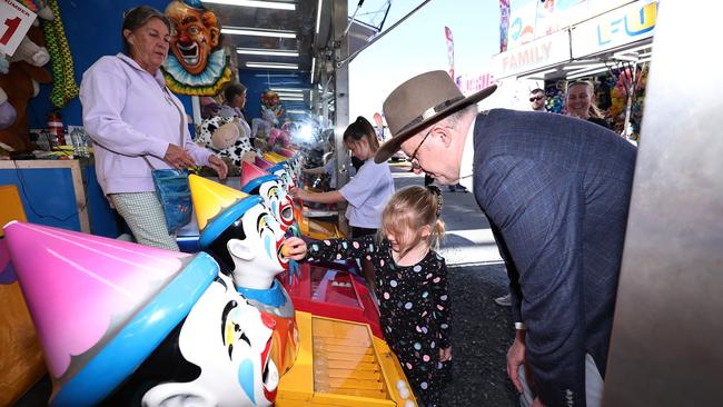 Autralian Prime Minister Anthony Albanese plays the famous clown game with Ariana Basile, 5, in sideshow alley on the final day of the Cairns Show. Picture: Brendan Radke