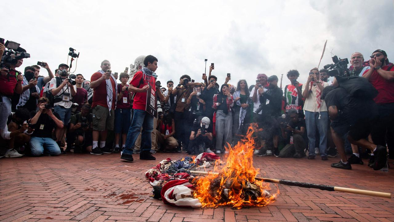 An American flag is burned outside Union Station. Picture: Matthew Hatcher/AFP