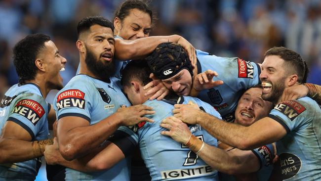 New South Wales players celebrate a try scored by Nathan Cleary (Photo by Trevor Collens / AFP)