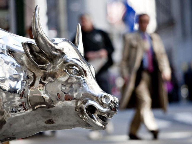 A man walks past a bull statue on Wall Street near the New York Stock Exchange in New York, U.S., on Monday, May 10, 2010. Stocks rallied around the world, sending the MSCI World Index up the most in 13 months, while Greek, Spanish and Portuguese bonds soared after European policy makers announced an almost $1 trillion loan package to end the region's sovereign-debt crisis. Photographer: Daniel Acker/Bloomberg