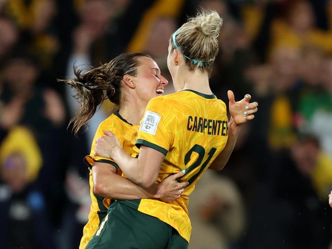 SYDNEY, AUSTRALIA - AUGUST 07: Hayley Raso (L) of Australia celebrates with teammates Ellie Carpenter (C) and Emily Van-Egmond (R) after scoring her team's second goal during the FIFA Women's World Cup Australia & New Zealand 2023 Round of 16 match between Australia and Denmark at Stadium Australia on August 07, 2023 in Sydney, Australia. (Photo by Mark Metcalfe - FIFA/FIFA via Getty Images)