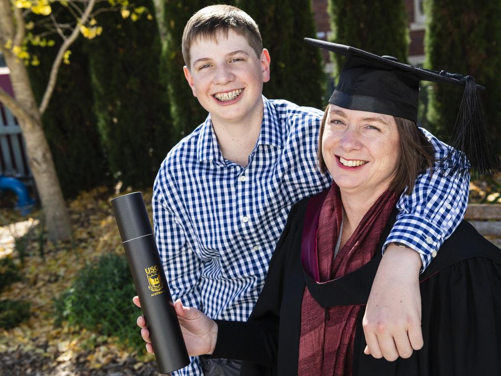 Curtis Cameron congratulates his mum Jenny Cameron on her Bachelor of Urban and Regional Planning degree at a UniSQ graduation ceremony at Empire Theatres, Wednesday, June 28, 2023. Picture: Kevin Farmer