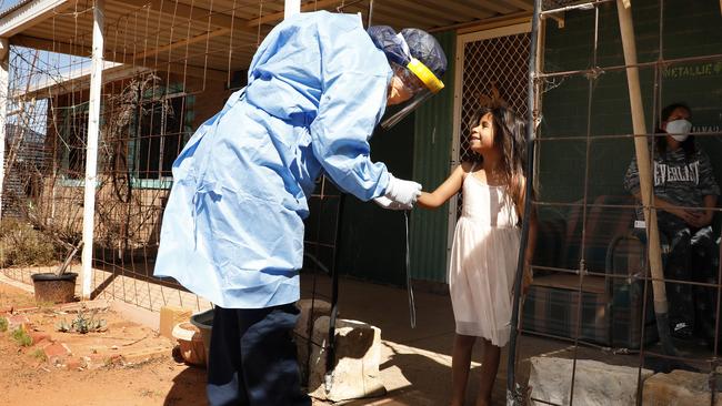 CareFlight nurse Melissa Price checks on Lakiah, 6, and her mother, Nicola Bates, in the northwest NSW town of Wilcannia on Monday. Picture: Chris Pavlich