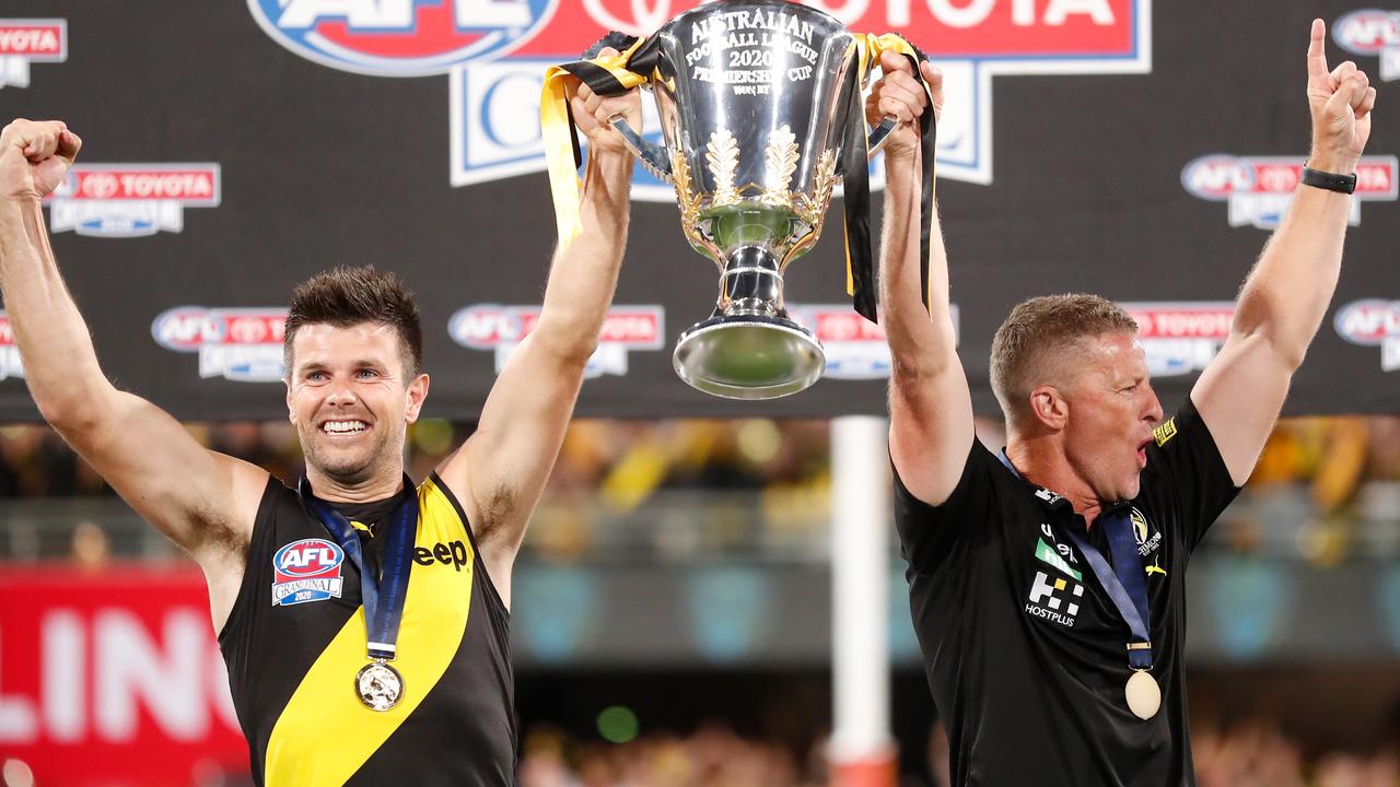 Trent Cotchin and Damien Hardwick lift the 2020 premiership cup at The Gabba.