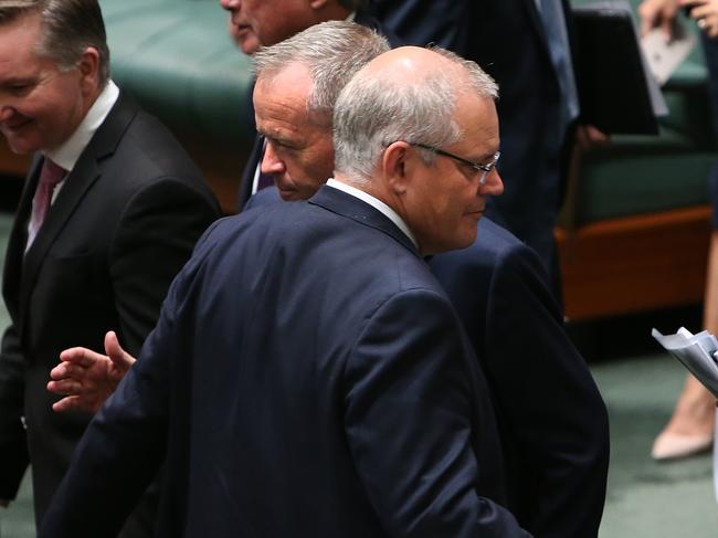 PM Scott Morrison and Opposition Leader Bill Shorten cross paths during a division in the House of Representatives Chamber at Parliament House in Canberra. Picture Kym Smith