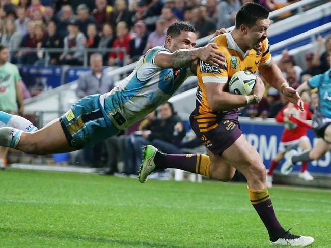 Broncos forward Alex Glenn escapes flying Titan Josh Hoffman to score a try during their clash at Suncorp Stadium last year. Picture: Peter Wallis