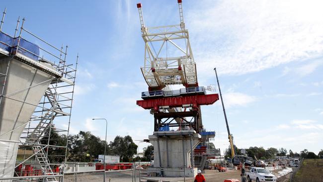 A crane going over Windsor Road at the site of the future Rouse Hill Town Centre train station.