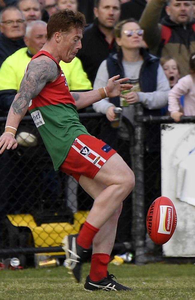 Aaron Ludewig kicks the winning point for Pines. Picture: Andy Brownbill