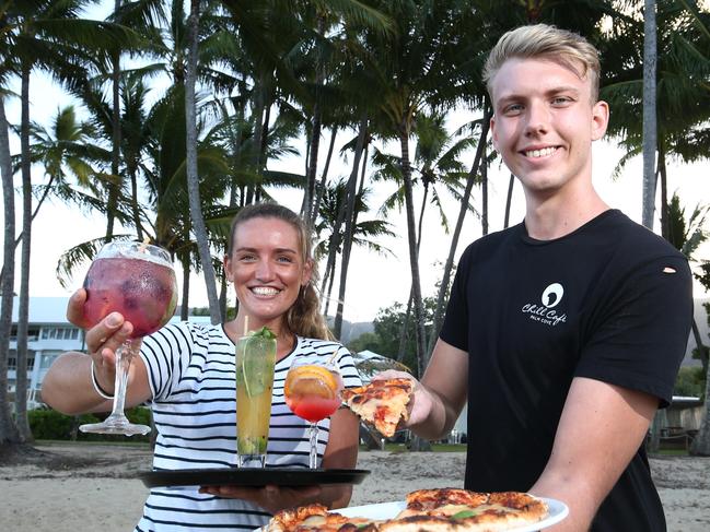 The Queensland Government has announced $99 flights to the Whitsundays to help kick start the tourism industry, but nothing for Cairns. Portofino hostess Elyssa Cawood and Chill Cafe waiter Scott Barry are ready to serve tourists at Palm Cove beach, Cairns. PICTURE: BRENDAN RADKE