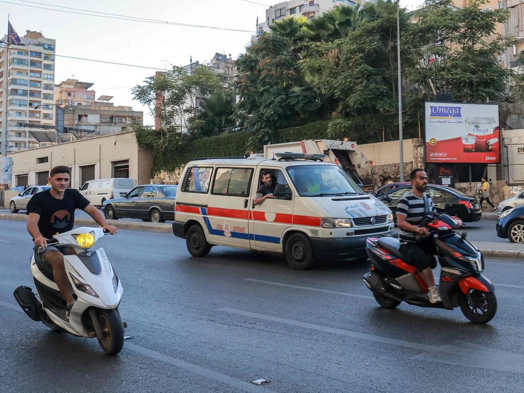 A Lebanese Red Cross ambulance rushes wounded people to a hospital in Beirut. (Photo by Ibrahim AMRO / AFP)