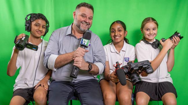 Prospect North Primary School students Ziaan, 11, Alina, 11 and Oti, 9 with principal Russell Barwel inside the interview room. Picture: Ben Clark