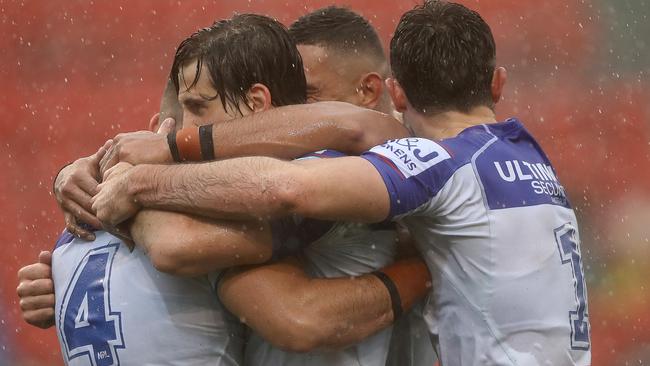 Jake Averillo (L) of the Bulldogs celebrates his try with team mates during the round 11 NRL match between the Newcastle Knights and the Canterbury Bulldogs at McDonald Jones Stadium.