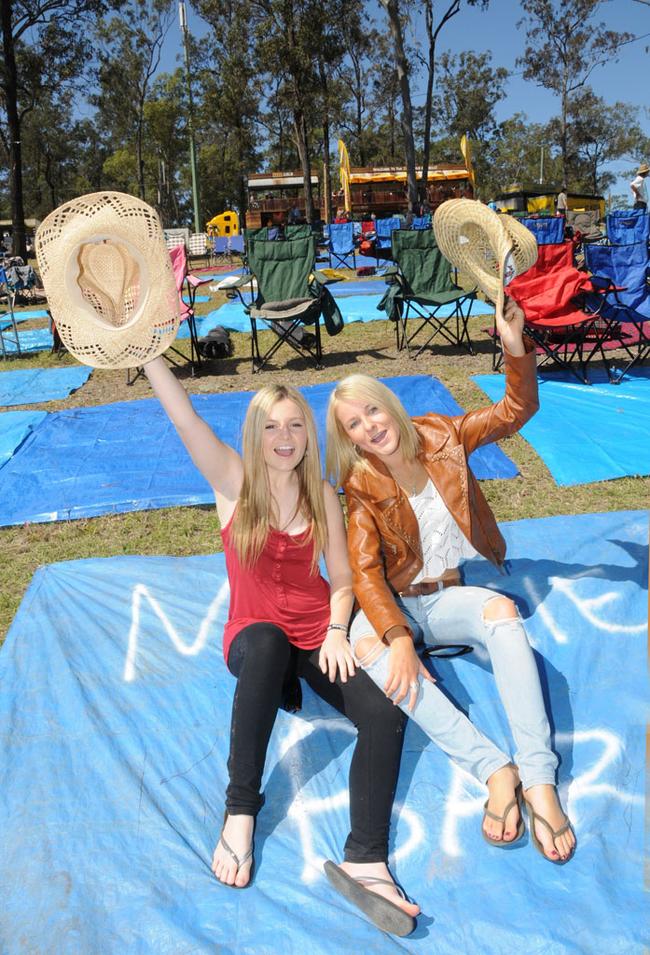 Abby Watson and Kolora Brew sit on their tarp yesterday afternoon waiting for Main Stage to kick of last night. Picture: Craig Warhurst