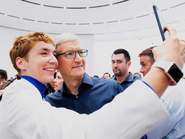 Apple CEO Tim Cook poses for a selfie with journalist Britta Weddeling during a launch event on September 12, 2018, in Cupertino, California. - New iPhones set to be unveiled Wednesday offer Apple a chance for fresh momentum in a sputtering smartphone market as the California tech giant moves into new products and services to diversify.Apple was expected to introduce three new iPhone models at its media event at its Cupertino campus, notably seeking to strengthen its position in the premium smartphone market a year after launching its $1,000 iPhone X. (Photo by NOAH BERGER / AFP)