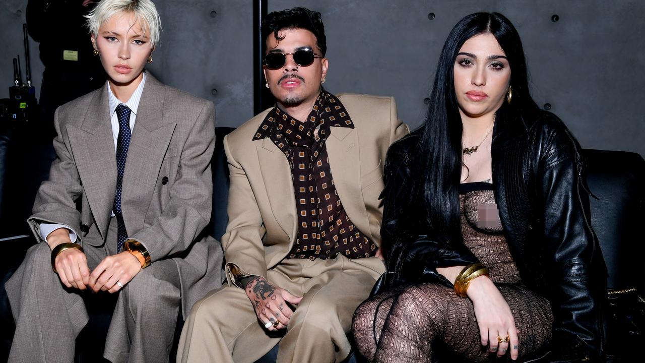 Taking a seat to watch the Saint Laurent show with Iris Law (left) and Rauw Alejandro (centre). Picture: Getty