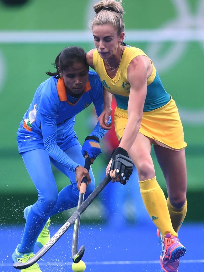 India's Vandana Katariya fights for the ball with Australia's Gabi Nance during the women's field hockey India vs. Australia match of the Rio 2016 Olympic Games at the Olympic Hockey Centre in Rio de Janeiro on August, 10 2016. / AFP PHOTO / MANAN VATSYAYANA