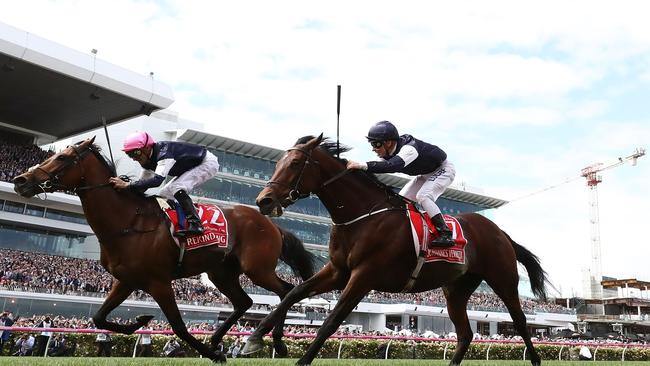 Corey Brown rides Rekindling, left, to win the Emirates Melbourne Cup. Picture: Getty Images