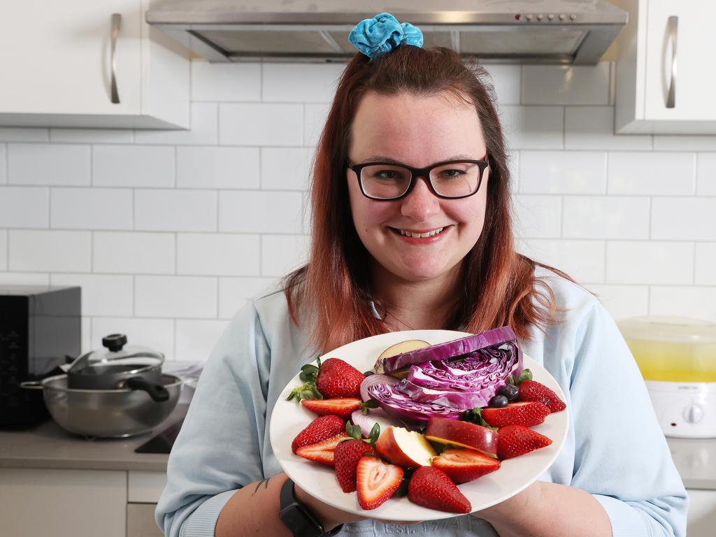 Asthma sufferer Lauren Brook with blue, red and purple foods used to prevent symptoms of exercise-induced bronchoconstriction. Picture: Liam Kidston