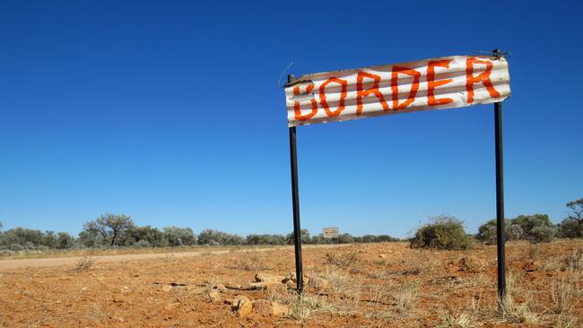 A sign marking the Northern Territory-Queensland border. The debate is raging as to when the NT should lift its border restrictions. Picture: Lee Atkinson