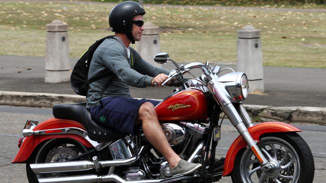 Brad Fittler rides his motorbike outside NRL headquarters in Moore Park in 2012.