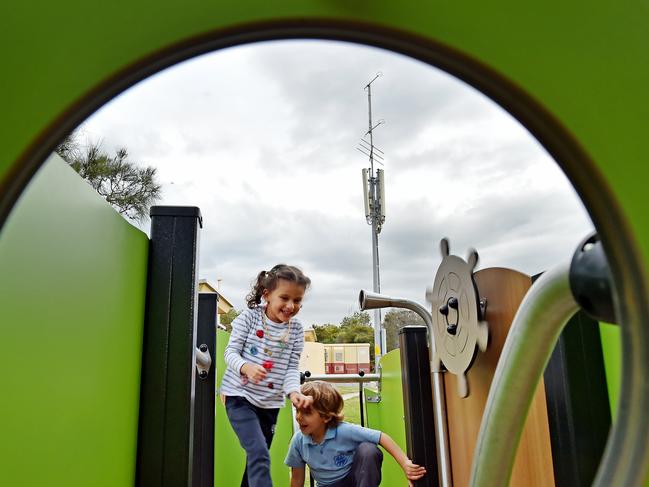 Children in the playground near a telecommunications towers at Tania Park, Balgowlah, which is due to be upgraded to 5G. Picture: Troy Snook.