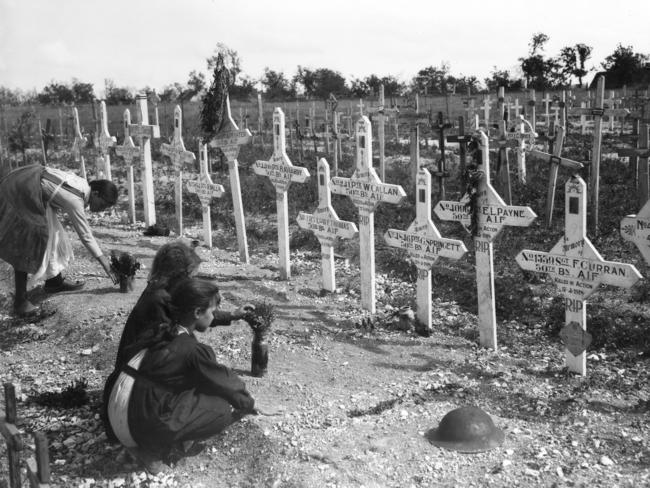 French children tend the graves of Australian soldiers at Adelaide Cemetery, Villers-Bretonneux, in 1919.