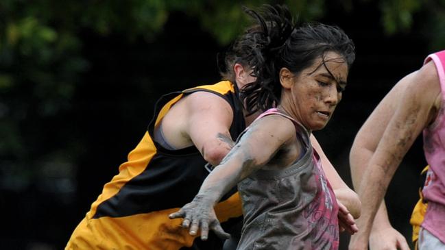 Waratah player Steph James kicks clear of her Nightcliff opponent in a fundraiser for breast cancer research. Picture: Justin Sanson.