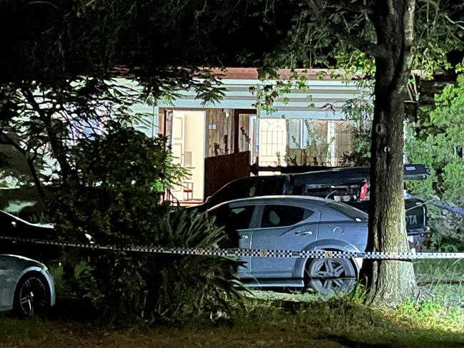 Police and ambulance officers at the scene where two bodies were found in Brisbane's outer southwest. Picture: Shaye Windsor