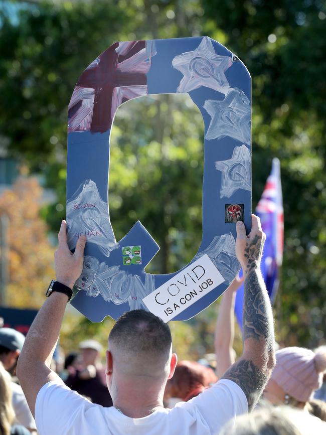 A man holds a sign referencing the Q-anon conspiracy theory. Picture Dean Martin