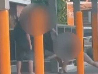 A pair has been caught on camera viciously attacking each other outside the Nambour Train Station.