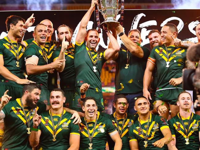 Australian team member's celebrate their victory in the Rugby League World Cup men's final match between Australia and England in Brisbane on December 2, 2017. / AFP PHOTO / Patrick HAMILTON / --IMAGE RESTRICTED TO EDITORIAL USE - STRICTLY NO COMMERCIAL USE--