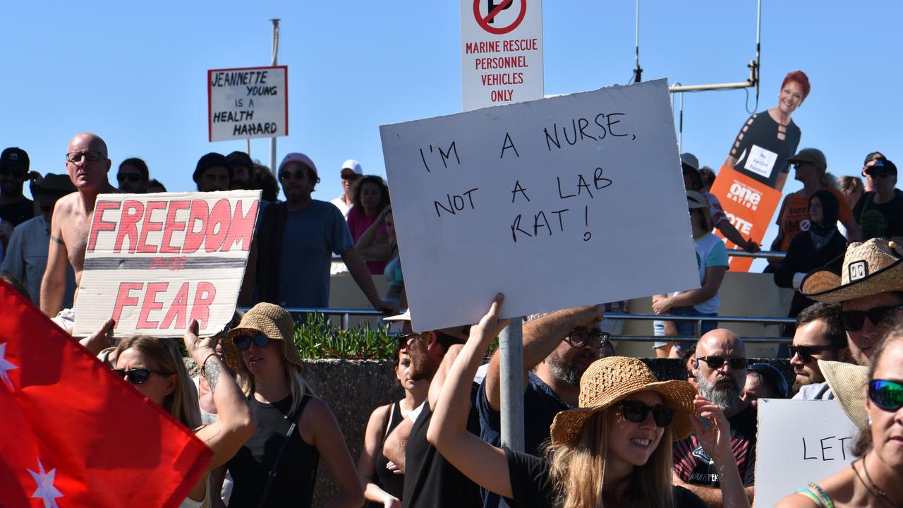 A sign reads ‘I’m a nurse not a lab rat!’. Photo: Liana Walker