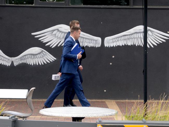 Police beside the bullet-marked wall at Sweet Lulus cafe. Picture: Andrew Henshaw