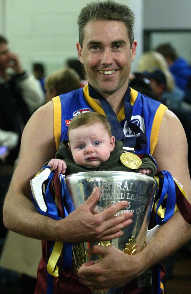 Premiers: Marcus Ashcroft with nephew Tyler after the 2003 AFL grand final.