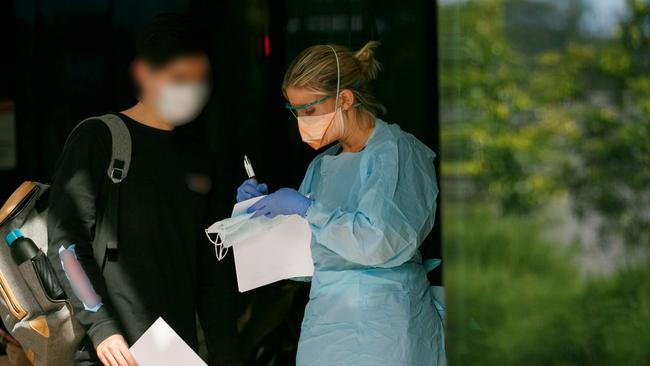 Patient in mask been seen by triage nurse at Northern Beaches Hospital's new COVID-19 clinic. Picture: Tim Pascoe