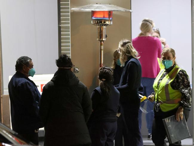 People and health officials pictured outside the Covid-19 locked down apartment building West Point on Campbell Street in Liverpool Picture: Damian Shaw