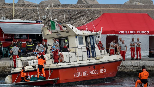 Italian firefighter divers bring ashore in a green bag the body of one of the victims of the UK flag vessel Bayesian - after the luxury sail yacht was hit by a violent sudden storm and sunk early Monday, while at anchor off the Sicilian village of Porticello near Palermo, in southern Italy. Picture: AP