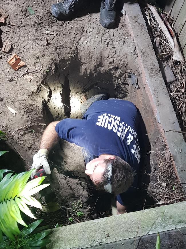 Firefighters had to dig up the backyard. Pictures: NSW Fire and Rescue (Narrabeen)