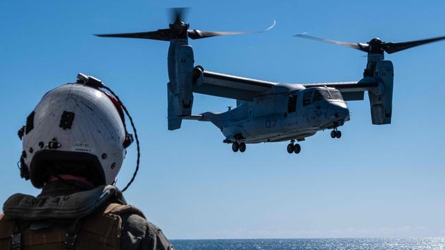 This handout photo taken on July 8, 2023 and released on July 26, 2023 by the US Marine Corps shows Capt. Andrew Johnson, an MV-22B Osprey tiltrotor aircraft pilot with Marine Medium Tiltrotor Squadron 363 (Reinforced), Marine Rotational Force - Darwin 23, watching an MV-22B Osprey land on Royal Australian Navy ship HMAS Adelaide (L01) during Exercise Southern Jackaroo 23, off the coast of Queensland, Australia. US military officials on August 28, 2023 named three marines killed in an aircraft crash in northern Australia, as investigators try to unearth clues about the cause of the incident. Corporal Spencer Collart, 21, Captain Eleanor LeBeau, 29, and Major Tobin Lewis, 37, were among 23 marines on board the Boeing MV-22B Osprey when it crashed on Melville Island, north of Darwin on the morning of August 27 during a military exercise for locally based troops. (Photo by Skyler M. HARRIS / US MARINE CORPS / AFP) / RESTRICTED TO EDITORIAL USE - MANDATORY CREDIT "AFP PHOTO / US MARINE CORPS /  Cpl. Skyler M. Harris" - NO MARKETING - NO ADVERTISING CAMPAIGNS - DISTRIBUTED AS A SERVICE TO CLIENTS